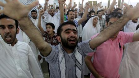 Bahraini Shiite Muslims chant slogans to free prisoners during a sermon Friday, June 10, 2011, in Diraz, Bahrain, when Sheik Issa Qassem, Bahrains top Shiite cleric, said Bahrain should free political prisoners and that the nations reputation is being damaged by prosecuting doctors, teachers, youths, women, clerics and other professionals arrested during the crackdown on anti-government protesters. Many Shiite Muslim clerics, including Sheik Ali Salman, leader of the largest opposition party, attended midday prayers in Diraz, an unusual move to show their solidarity with Qassem.