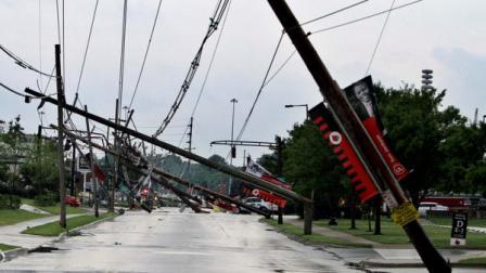 A row of electric power poles snapped along Floyd Street at Central Avenue in front of Cardinal Stadium at the University of Louisville in Louisville, Ky., Wednesday, June 22, 2011 after an apparent tornado moved through the area. At least five barns were damaged and horses were running loose Wednesday at Churchill Downs, home of the Kentucky Derby, after a powerful storm that spawned tornadoes blew through Louisville. (AP Photo/Garry Jones)