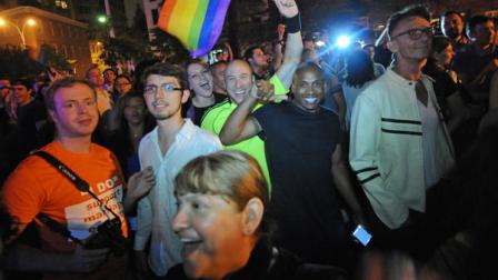 Revelers celebrate in Manhattans west village following the passing of the same sex marriage bill by a vote of 33 to 29, Friday, June 24, 2011, in New York. Same-sex marriage is now legal in New York after Gov. Andrew Cuomo signed a bill that was narrowly passed by state lawmakers Friday, handing activists a breakthrough victory in the state where the gay rights movement was born. (AP Photo/Louis Lanzano)