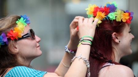 Inga Ryabchikova, left, ties a rainbow lei on Ashley DAmico before the start of the annual Gay Pride parade Sunday, June 26, 2011 in New York. One of the worlds oldest and largest gay pride parades was expected to become a victory celebration Sunday after New Yorks historic decision to legalize same-sex marriage. The law signed by Gov. Andrew Cuomo on Friday doesnt take effect for 30 days.