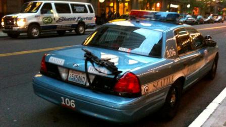 This handout photo provided by Nick Gonzalez for editorial purposes only, shows a police rifle left unattended on a patrol car outside a busy downtown area on Tuesday, June 28, 2011, in Seattle. A Seattle police spokesman says the department has launched an investigation into the incident. Rifles are assigned only to officers who have additional training and are usually kept in the trunk or between the driver and passenger seats.
