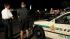 Orange County Sheriffs deputies guard the street...