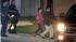 Casey Anthony, center, walks to a SUV with her...