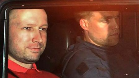 Norways twin terror attacks suspect Anders Behring Breivik, left, sits in an armored police vehicle after leaving the courthouse following a hearing in Oslo Monday July 25, 2011