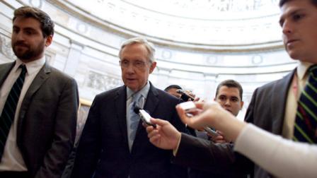 Senate Majority Leader Harry Reid, D-Nev., speaks with reporters as he walks across the Capitol on his way to the office of House Democratic Leader Nancy Pelosi, D-Calif., as national debt crisis negotiations continue on Capitol Hill in Washington on Sunday, July 31, 2011. (AP Photo/Harry Hamburg)