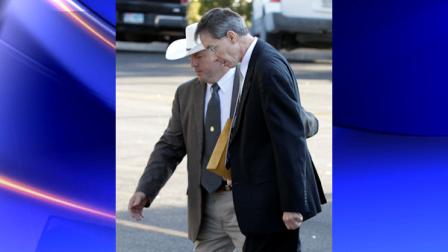 A law enforcement officer, left, escorts polygamist religious leader Warren Jeffs, right, into the Tom Green County Courthouse Thursday Aug. 4, 2011, in San Angelo, Texas. (AP Photo/Tony Gutierrez)