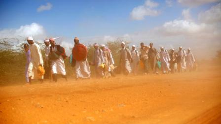 Muslim clerics walk in the dust on the dirt road outside Dadaab, eastern Kenya, 100 kms (60 miles) from the Somali border, Sunday Aug. 7, 2011. The drought and famine in the horn of Africa has killed more than 29,000 children under the age of 5 years in the last 90 days in southern Somalia alone, according to U.S. estimates. The U.N. says 640,000 Somali children are acutely malnourished, suggesting the death toll of small children will rise.