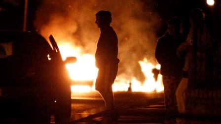 A fire is seen during civil disturbances in Salford near Manchester, England, Tuesday, Aug. 9 2011. Police in the city of Manchester, in northwestern England, said seven people had been arrested so far, as youths rampaged through the city center, which had not previously been touched by the violence, arson and looting that has swept through London and other major cities since Saturday night.