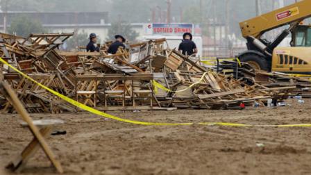 Indiana State Police and authorities survey the collapsed rigging and Sugarland stage on the infield at the Indiana State Fair in Indianapolis, Sunday, Aug. 14, 2011. Five people died in the stage collapse. (AP Photo/Darron Cummings)