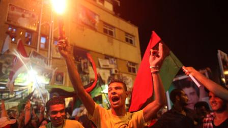 People celebrate the recent news of uprising in Tripoli against Moammar Gadhafis regime at the rebel-held town of Benghazi, Libya, early Sunday, Aug. 21, 2011. Libyan rebels said they launched their first attack on Tripoli in coordination with NATO late Saturday, and Associated Press reporters heard unusually heavy gunfire and explosions in the capital. The fighting erupted just hours after opposition fighters captured the key city of Zawiya nearby. (AP Photo/Alexandre Meneghini)