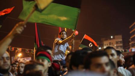 People celebrate the recent news of uprising in Tripoli against Moammar Gadhafis regime at the rebel-held town of Benghazi, Libya, early Sunday, Aug. 21, 2011. Libyan rebels said they launched their first attack on Tripoli in coordination with NATO late Saturday, and Associated Press reporters heard unusually heavy gunfire and explosions in the capital. The fighting erupted just hours after opposition fighters captured the key city of Zawiya nearby. (AP Photo/Alexandre Meneghini)