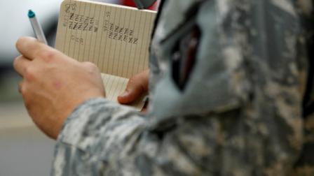 Kevin Flannery, of the New Jersey National Guard, keeps a tally of people that boarded buses at the Sun Center in Trenton, N.J., as officials moved them into a shelter at Rutgers University in preparation for the arrival of Hurricane Irene, Saturday, Aug. 27, 2011. (AP Photo/Julio Cortez)