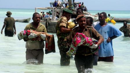 Tanzanian police carry bodies of children from the sea in Zanzibar, Tanzania, Saturday Sept 10, 2011. An overcrowded ship sank in deep sea off mainland Tanzania on Saturday with about 600 people onboard, and about 370 people are believed missing or dead. The ferry, M.V. Spice Islanders, was heavily overloaded and some potential passengers had refused to board when it was leaving the mainland port of Dar es Salaam, said survivor Abdullah Saied. It sank in an area with heavy currents in deep sea between mainland Tanzania and Pemba Island at about 1 a.m. Saturday. About 230 people had been rescued and 40 bodies had been recovered, said Mohamed Aboud, the minister for the vice presidents office. (AP Photo/Ali Sultan)