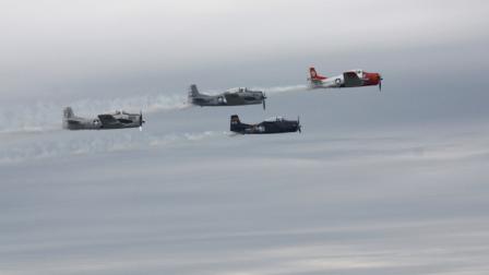 Four of the crashed pilots fellow T-28 pilots flew over the crash site a few minutes after the incident during an air show in Martinsburg, W.Va. on Saturday, Sept. 17, 2011. The pilot of the post-World War II plane died after crashing into a runway and bursting into flames. (AP Photo/Ross Simpson)