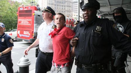 Police take a participant, center, from a march organized by Occupy Wall Street after handcuffing him Saturday Sept. 24, 2011 in New York. Marchers represented various causes both political and economic. (AP Photo/Tina Fineberg)