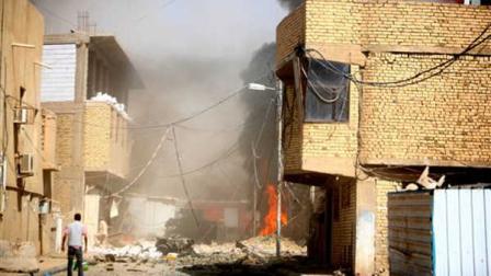 A man inspects the scene of a bomb attack in Karbala, 80 kilometers (50 miles) south of Baghdad, Iraq, Sunday, Sept. 25, 2011. A series of blasts hit a Shiite holy city in Iraq on Sunday, killing and wounding scores of people, police and hospital officials said.