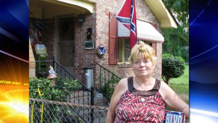 Annie Chambers Caddell stands outside her home in Summerville, S.C., on Thursday, Oct. 14, 2010. The Confederate flag behind her has raised concern in her predominantly black neighborhood, and neighbors plan a protest march. 