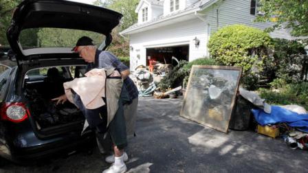 Robert Gordon sorts through items from his destroyed home damaged during floods in the aftermath of Hurricane Irene, Monday, Sept. 26, 2011, in Wayne, N.J. Gordon and his wife, Martha, say the are moving to Maine because the house in which they lived in for 50 years has to be demolished. Martha Gordon has talked to FEMA, but doesnt expect any quick relief aid.