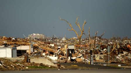 FILE - In this May 30, 2011, file photo damage is seen in a devastated Joplin, Mo. neighborhood. A federal agency was set to release a report Tuesday, Sept. 20, 2011, detailing communication efforts ahead of the massive twister that hit Joplin, killing more than 160 people.