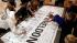 Fans sign a tribute banner before a memorial...