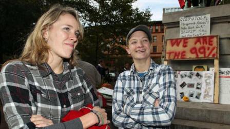 In this Monday, Oct. 24, 2011 photo, protesters who identified themselves as Savanah Kite, left, and Trish Phelan stand in Burnside Park where the Occupy Providence protesters are camped in downtown Providence, R.I. The duo said they intend on staying in the park indefinitely and are preparing for the upcoming winter weather.