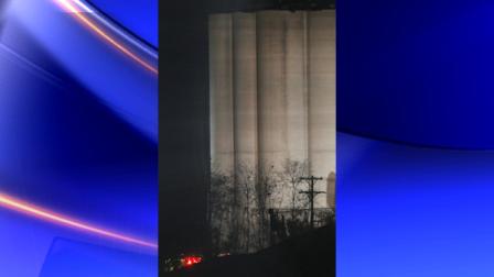 Lights from emergency vehicles flash near the bottom of a grain elevator in Atchison, Kan., Saturday, Oct. 29, 2011. An explosion at the Bartlett Grain Co. elevator injured at least two people. (AP Photo/Orlin Wagner)