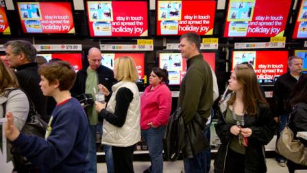 Shoppers wait in line to purchase electronic items on sale a Target store in Roswell, Ga., which opened at midnight on Friday, Nov. 25, 2011 for the Christmas shopping season. Black Friday began in earnest as stores opened their doors at midnight. (AP Photo/Rich Addicks)