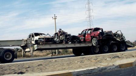 Vehicles destroyed by a suicide car bomb explosion are towed away in the town of Taji, about 12 miles (20 kilometers) north of Baghdad, Iraq, Monday, Nov. 28, 2011. A suicide bomber slammed a car packed with explosives into the gate of a prison north of Baghdad on Monday, killing and wounding scores of people, police said.