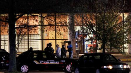 Law enforcement officers gather outside the Winton Blount U.S. Post Office in Montgomery, Ala., after a gunman opened fire inside the structure, Thursday, Dec. 1, 2011. No one was injured and authorities have a suspect in custody. The post office was evacuated and surrounding streets were cordoned off by police during the incident. (AP Photo/Dave Martin)