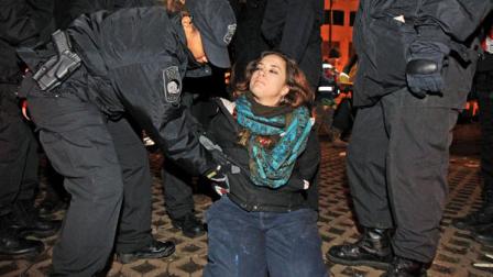 Boston police officers remove an Occupy Boston protester from Dewey Square in Boston before dawn Saturday, Dec. 10, 2011. More than 40 people were peacefully arrested as the park was cleared. The city had set a Thursday midnight deadline for protesters to leave or face eviction. (AP Photo/The Boston Globe, Essdras M Suarez, , Pool)