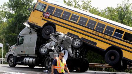 FILE - In this Aug. 5, 2010 file photo, a rescue worker is seen at the scene of an accident involving two school buses, a tractor-trailer and another passenger vehicle, near Gray Summit, Mo. Federal safety investigators say a 19-year-old driver was texting at the time his pickup truck, two school buses and other vehicles collided in a deadly pileup on an interstate highway in Missouri last year. The National Transportation Safety Board (NTSB) released the information Monday. The board is scheduled to meet Tuesday to hear the results of an investigation into the accident near Gray Summit, Mo., and to make safety recommendations.