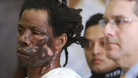 Jerome Isaac, 47, left, appears at his arraignment in the Brooklyn borough of New York Monday, Dec. 19, 2011, where he was charged with murder and arson in the death of Delores Gillespie, 73, who was burned to death in the elevator of her Brooklyn, apartment building. Isaac is accused of spraying gasoline on Gillespie and setting her ablaze in the elevator. At right is Isaacs attorney Howard Tanner.