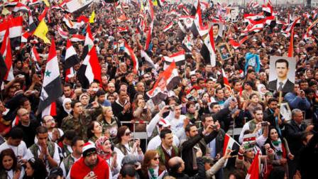 Pro-regime protesters chant slogans during a rally at Umayyad Square in Damascus, Syria, Wednesday, Dec. 21, 2011. Syrian troops assaulting a northwest town with machine gun fire and shelling have killed dozens in one of the deadliest episodes of the 9-month-old uprising against President Bashar Assads regime, activists said Wednesday.