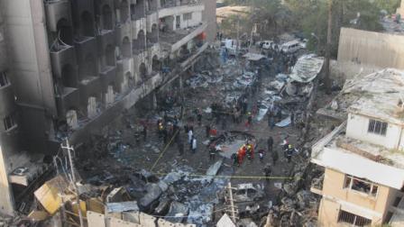 Iraqi security forces gather the scene of a car bomb attack in Baghdad, Iraq, Thursday, Dec. 22, 2011. A wave of bombings ripped across Baghdad on Thursday morning killing and wounding hundreds of people, Iraqi officials said, in the worst violence Iraq has seen for months. The bloodbath comes just days after American forces left the country.