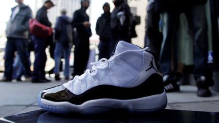 A newly-purchased Air Jordans sneaker is shown in front of a line of customers at the Nike Store at Union Square Friday, Dec. 23, 2011 in San Francisco. The release of Nikes retro Air Jordans caused a frenzy at stores across the nation early Friday, with hundreds of people lining up for a chance to buy the classic basketball shoes and rowdy crowds breaking down doors and starting fights in at least two cities. (AP Photo/Marcio Jose Sanchez)