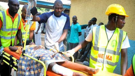 Medical officials try to treat a victim of a bomb blast at a Catholic church near Nigerias capital at Suleja General Hospital in Suleja, Nigeria, Sunday, Dec. 25, 2011. An explosion ripped through a Catholic church during Christmas Mass near Nigerias capital Sunday, killing at least 25 people, officials said. A radical Muslim sect claimed the attack and another bombing near a church in the restive city of Jos, as explosions also struck the nations northeast.(AP Photo/Dele Jones)