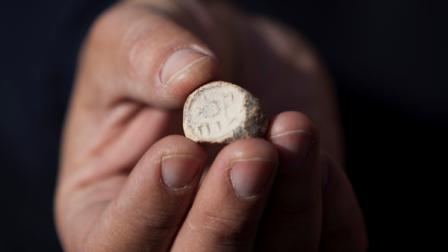 A rare clay seal is displayed during a news conference at the archaeological site known as the City of David in east Jerusalem, Sunday, Dec. 25, 2011. Israeli archaeologists say they have unearthed a rare clay seal that appears to be linked to religious rituals that took place at the Jewish Temple 2,000 years ago.