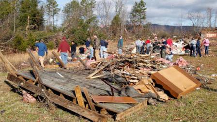 The wooden back deck of Byron Coles home sits cluttered while his friends and family help to clean-up the storm damage near Ellenboro, N.C. Thursday Jan. 12, 2012. At least 15 people were injured and at least 60 buildings damaged when a possible tornado struck in western North Carolina, the National Weather Service said Thursday. The storms struck in Rutherford and Burke counties late Wednesday afternoon as a cold front moved through the western Carolinas, meteorologist Neil Dixon with the weather service office in Greer, S.C., said. (AP Photo/Bob Leverone)