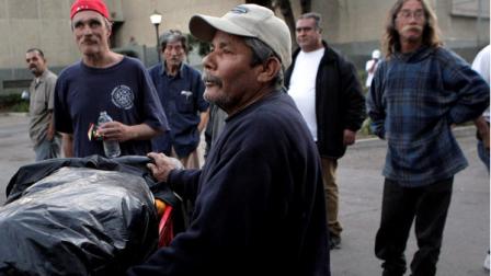 Homeless people wait in line to pick up hygiene kits in Santa Ana , Calif., Thursday, Jan. 5, 2012. Homeless people in Orange County are put on alert by police and advocates concerned that theyre the target of a serial killer who has already slain three homeless men. Police said an attacker has stabbed three homeless people to death in north Orange County. (AP Photo/Jae C. Hong)