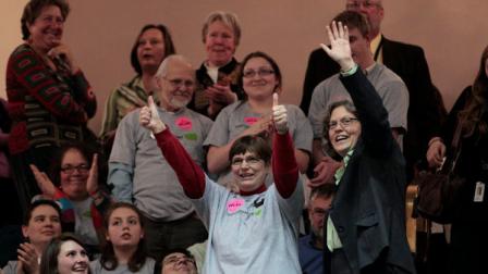 Rep. Laurie Jinkins, right, D-Tacoma, waves with constituent Marcy Kulland from one Senate gallery across to the other Wednesday, Feb. 1, 2012, in Olympia, Wash. The state Senate is set to vote Wednesday night on a proposal to legalize same-sex marriage in Washington state. If passed by the Senate, the measure moves to the House, which has enough votes to pass the bill. Democratic Gov. Chris Gregoire supports the measure and said she will sign it into law. (AP Photo/Elaine Thompson)