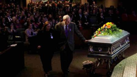 Chuck Cox reaches out to touch the casket bearing his grandsons, Charlie and Braden, as he walks with his wife Judy during a funeral service the two boys, Saturday, Feb. 11, 2012, in Tacoma, Wash. The boys died Feb. 5, 2012, when their father, Josh Powell, set fire to the home he was living in while they visited. Powell had been a person of interest in the 2009 disappearance of his wife Susan. (AP Photo/Ted S. Warren, Pool)