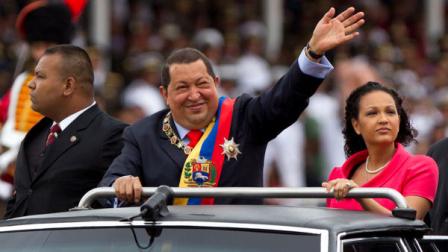 Venezuelas President Hugo Chavez waves during a military parade to commemorate the XX th anniversary of a 1992 failed coup attempt led by him when he was a lieutenant colonel in Caracas, Venezuela, Saturday, Feb. 4, 2012. At right is Chavezs daughter Rosa Virginia Chavez. Venezuelas Vice President Nicolas Maduro announced on Tuesday, March 5, 2013 that Chavez has died. Chavez, 58, was first diagnosed with cancer in June 2011. (AP Photo/Ariana Cubillos)