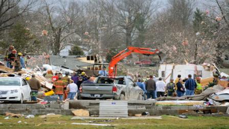 Emergency responders work to clear debris in a neighborhood in Harrisburg, Ill., after an early morning tornado Wednesday, Feb. 29, 2012. At least six people died in Harrisburg in the pre-dawn tornado.