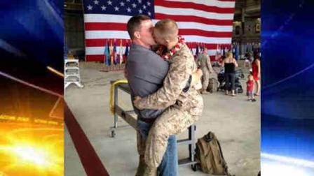 Sgt. Brandon Morgan, right, is embraced by his partner Dalan Wells in a helicopter hangar at a Marine base in Kaneohe Bay, Hawaii, upon returning from a six-month deployment to Afghanistan in this photo made Wednesday, Feb. 22, 2012. The photo, made some five months after the repeal of the militarys dont ask dont tell policy prohibiting gay servicemen from openly acknowledging their sexuality, is among the first showing a gay active duty serviceman in uniform kissing his partner at a homecoming. (AP Photo/David Lewis)