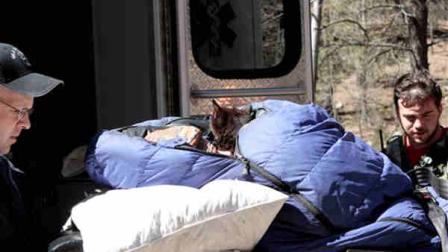 This image provided by David Kuthe shows missing hiker Margaret Page with her cat, being loaded into an ambulance March 7, 2012 inside the Gila National Forest, N.M. Page who had been missing for nearly a month, was found malnourished and emaciated but well-hydrated. Authorities believed she had probably stayed alive by drinking water from a nearby creek (AP Photo/David Kuthe, Glenn Tolhurst)