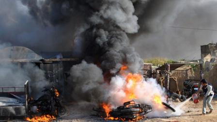 A Palestinian tries to extinguish a fire after an Israeli airstrike in Rafah, southern Gaza Strip, Saturday, March 10, 2012. The airstrike killed Popular Resistance Committees militant Mahdi Abu Shawesh. Despite Egyptian efforts to mediate a cease-fire, both sides remained defiant with Palestinians firing more than 100 rockets, some striking major cities in southern Israel, and the military responding with the targeted killings of more than 15 militants. (AP Photo)