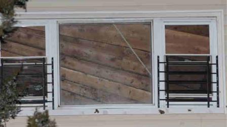 Authorities say a floor of a New York City building where a party was being held collapsed, injuring a dozen people. The Fire Department said two people were hospitalized. One was seriously injured. The collapsed ceiling is seen through a second floor window of th house that suffered an internal collapse in the Rockaway section of Queens, New York, early Sunday, March 18, 2012. (AP Photo/Robert Mecea)