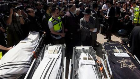 Friends and family members gather around the bodies of the victims of Mondays shooting in Toulouse, France during their funeral at a cemetery in Jerusalem, Wednesday, March 21, 2012.