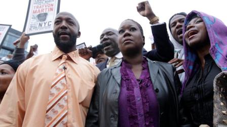Trayvon Martins parents Tracy Martin, left, and Sybrina Fulton, center, are joined by an unidentified woman during the Million Hoodie March in Union Square Wednesday, March 21, 2012 in New York. A few hundred people are marching in New York City in memory of Trayvon Martin, a black teenager shot to death by a Hispanic neighborhood watch captain in Florida. The teenager was unarmed and was wearing a hoodie. (AP Photo/Mary Altaffer)