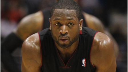Miami Heats Dwayne Wade (3) and teammate LeBron James, rear, look on during the second half of an NBA basketball game against the Milwaukee Bucks on Wednesday, Feb. 1, 2012, in Milwaukee. The Bucks won 105-97. (AP Photo/Jeffrey Phelps)